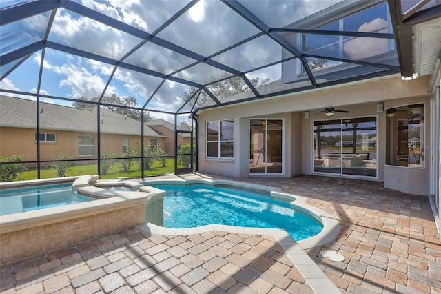 view of swimming pool with a patio, a lanai, an in ground hot tub, and ceiling fan