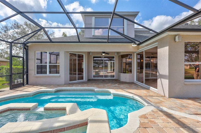 view of pool with an in ground hot tub, ceiling fan, a lanai, and a patio area