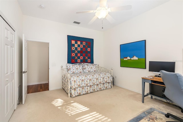 bedroom with carpet, ceiling fan, and a closet