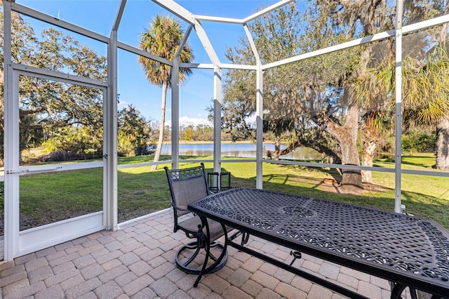 unfurnished sunroom featuring a water view