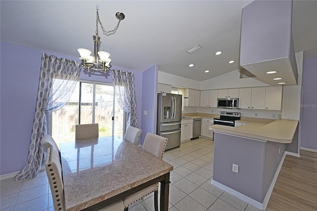 kitchen featuring white cabinets, a peninsula, stainless steel appliances, light countertops, and pendant lighting