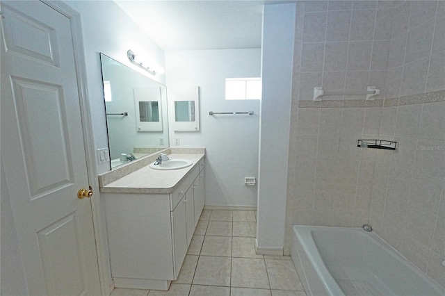 bathroom featuring vanity, baseboards, and tile patterned floors