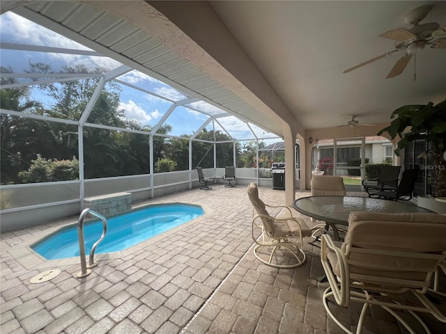 view of pool with a grill, a lanai, a patio, and ceiling fan