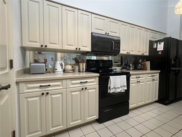 kitchen with white cabinetry, light tile patterned flooring, and black appliances