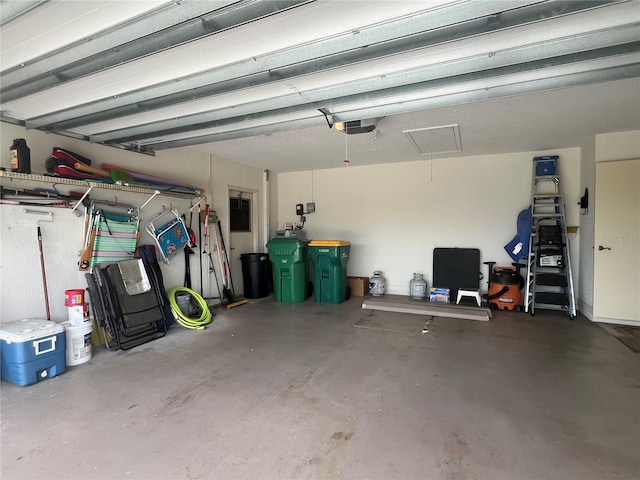 garage with a garage door opener and electric panel