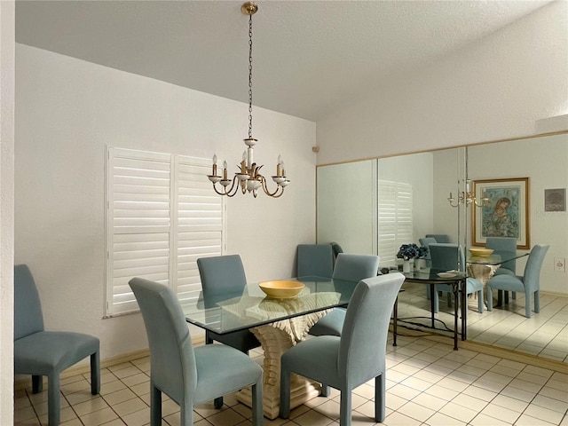 tiled dining space featuring lofted ceiling and a chandelier