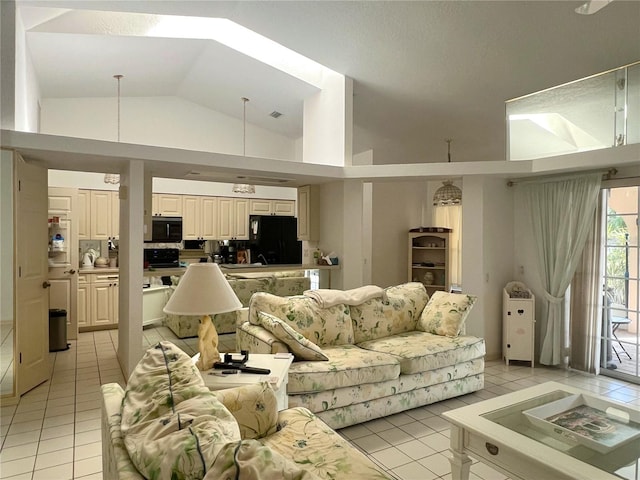 living room featuring vaulted ceiling and light tile patterned floors