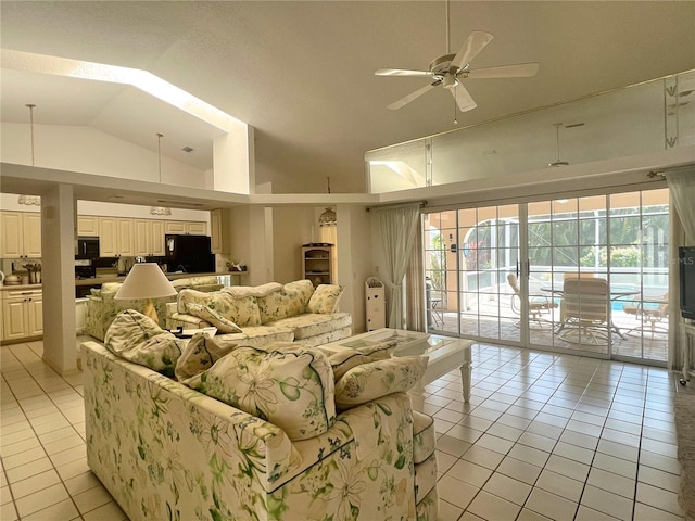 tiled living room featuring ceiling fan and vaulted ceiling