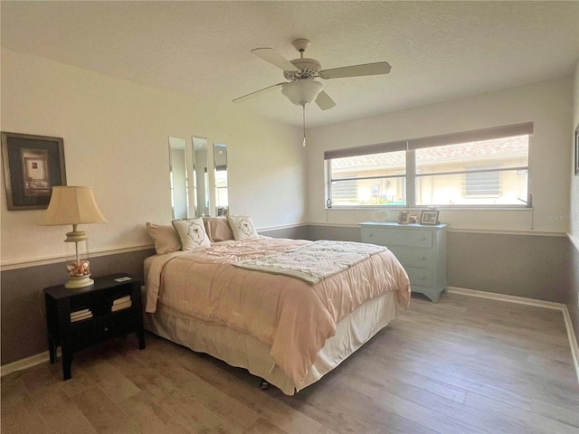 bedroom with hardwood / wood-style floors and ceiling fan