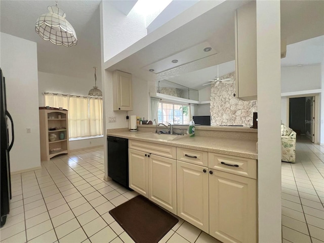 kitchen featuring sink, decorative light fixtures, black appliances, and light tile patterned floors