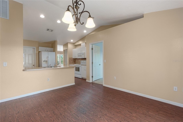 unfurnished living room with baseboards, visible vents, vaulted ceiling, and dark wood finished floors