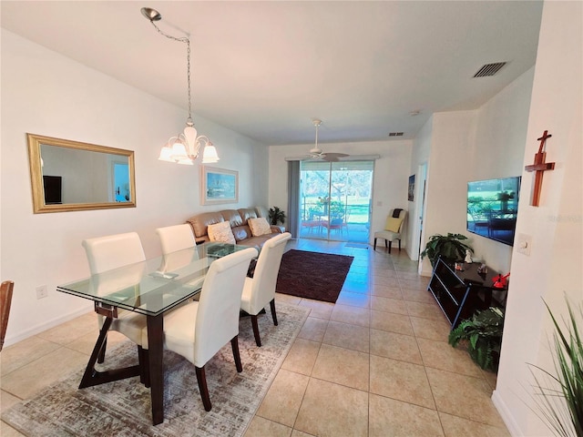 dining area with light tile patterned floors, visible vents, baseboards, and an inviting chandelier