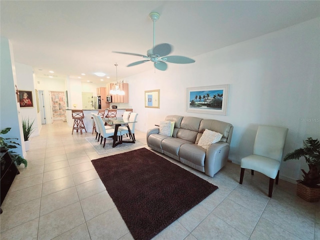 living area with light tile patterned floors and a ceiling fan