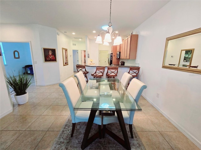 dining area featuring light tile patterned floors, baseboards, and an inviting chandelier