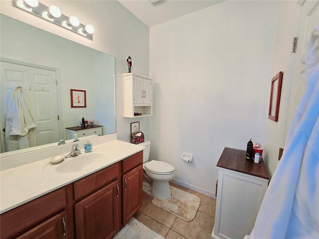 full bath with tile patterned flooring, baseboards, vanity, and toilet