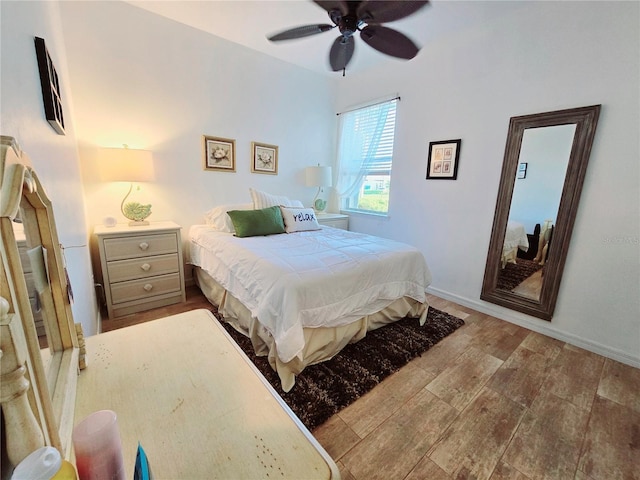 bedroom with ceiling fan and baseboards