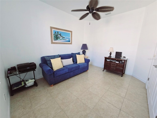 living room with a ceiling fan, visible vents, and baseboards