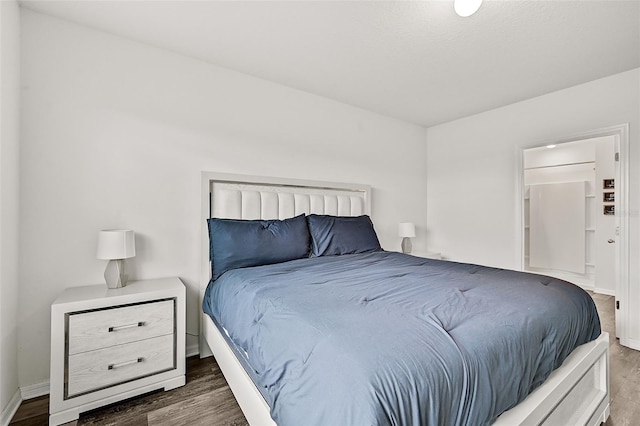 bedroom with dark hardwood / wood-style flooring