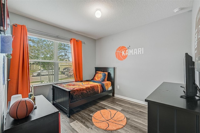 bedroom featuring a textured ceiling and light hardwood / wood-style floors