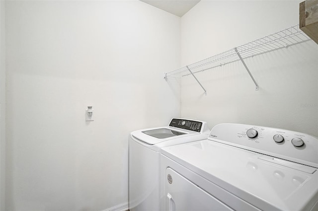 clothes washing area featuring washer and clothes dryer