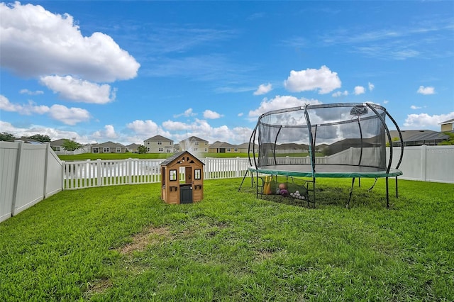 view of yard featuring a trampoline and a playground