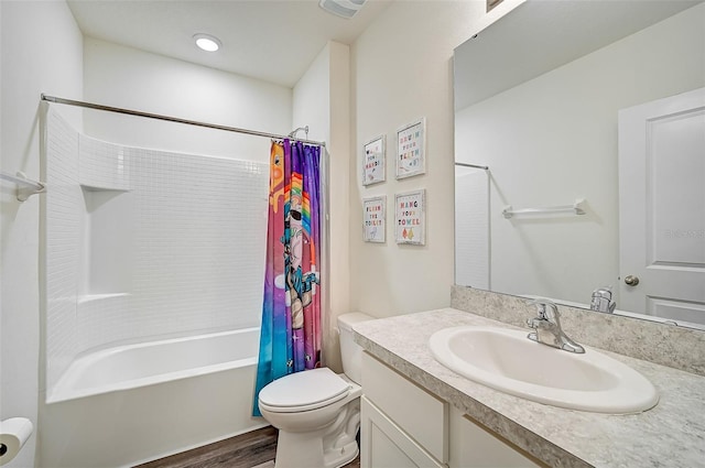 full bathroom with hardwood / wood-style flooring, shower / bath combination with curtain, vanity, and toilet