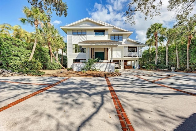 view of front of home with a carport and a porch