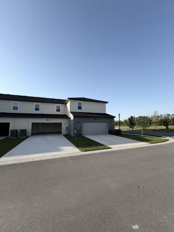 view of front of home featuring an attached garage and concrete driveway
