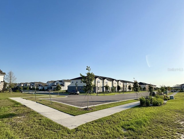 surrounding community featuring a yard and a residential view