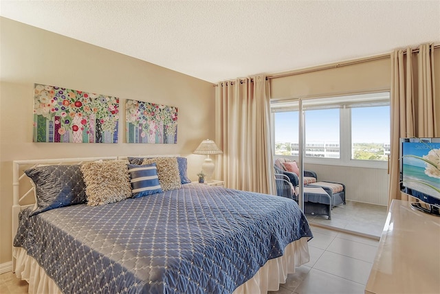 tiled bedroom with a textured ceiling