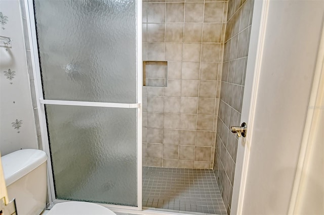 bathroom with walk in shower and toilet