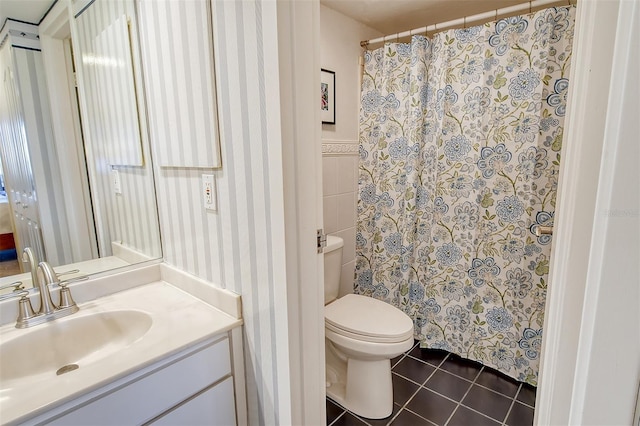 bathroom with vanity, tile walls, tile patterned floors, and toilet