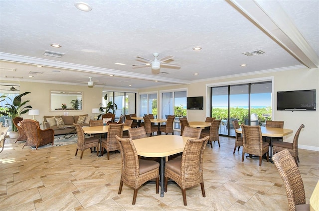 dining space featuring ceiling fan, ornamental molding, and a textured ceiling