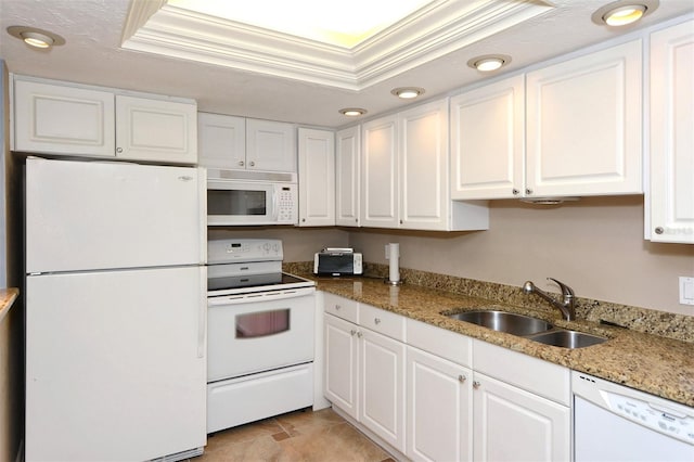 kitchen featuring sink, white cabinets, light stone counters, a tray ceiling, and white appliances