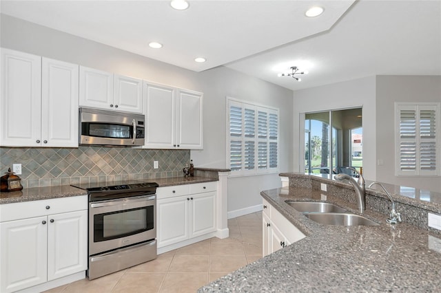 kitchen featuring stainless steel appliances, sink, and white cabinets