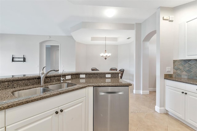 kitchen featuring white cabinets, dishwasher, sink, and dark stone countertops