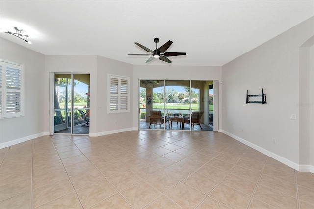 tiled spare room with ceiling fan