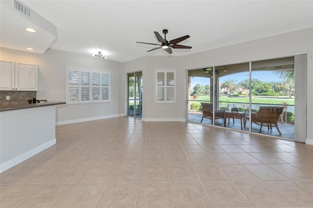 unfurnished living room featuring light tile patterned flooring and ceiling fan