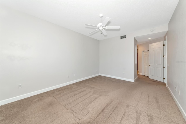 carpeted spare room with ceiling fan