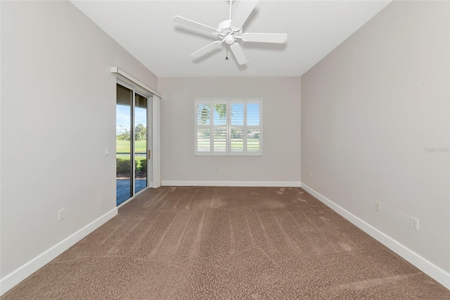 carpeted spare room featuring ceiling fan