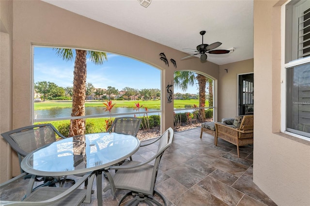 view of patio / terrace with a water view and ceiling fan