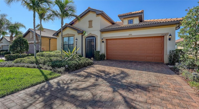 mediterranean / spanish-style house with a garage