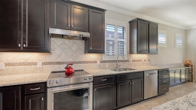 kitchen with sink, light tile patterned flooring, crown molding, stainless steel appliances, and decorative backsplash