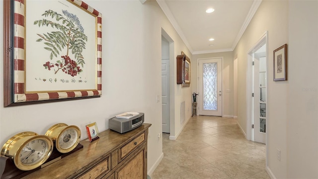 entryway with light tile patterned floors and ornamental molding