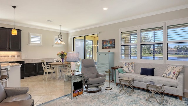 living room featuring ornamental molding and light tile patterned floors