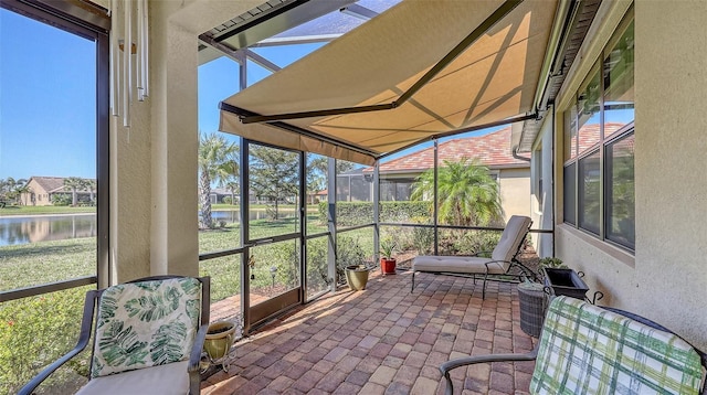 sunroom featuring a water view and a healthy amount of sunlight