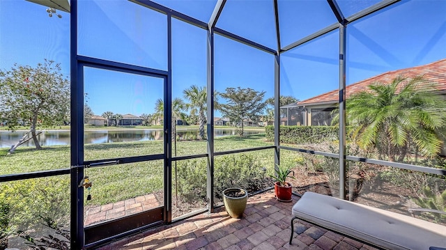 unfurnished sunroom featuring a water view