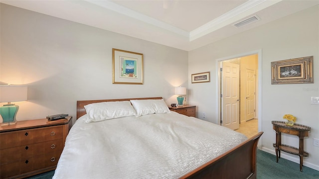 carpeted bedroom with a raised ceiling