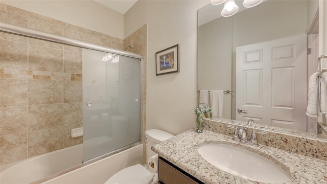 full bathroom featuring toilet, vanity, and combined bath / shower with glass door