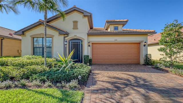 mediterranean / spanish-style home with a garage